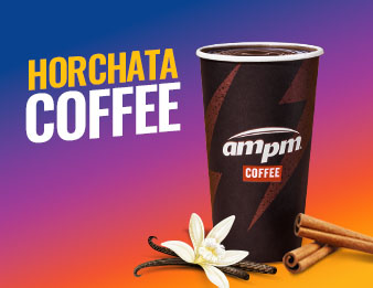 A vanilla bean flower beside a cup of horchata coffee