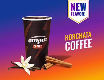 A vanilla bean flower and cinnamon sticks beside a cup of Horchata Coffee