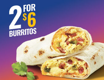 Two Egg & Bacon burritos beside a sprig of cilantro