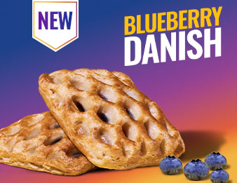 Two of the new blueberry danishes beside some fresh blueberries