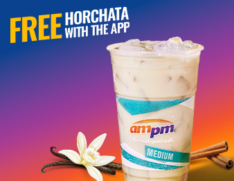 A vanilla bean flower beside a cup of ampm horchata
