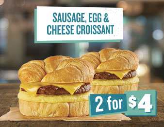 Put a sausage in your croissant, A picture of two large breakfast sandwiches next to each other. The text reads Sausage, egg, and cheese croissant. Two for four dollars.