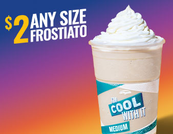 A frostiato in a cup with whip cream